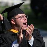 Man grad clapping in seat