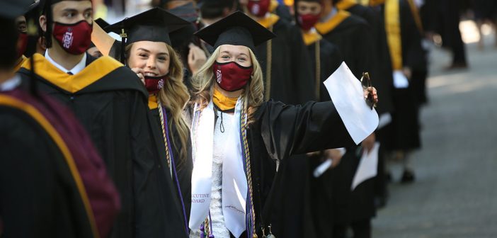 student in line-up with caps and gowns