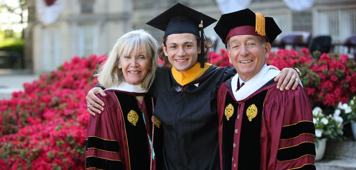 Board chair Bob Daleo and his wife, Linda, flanking their nephew how graduated
