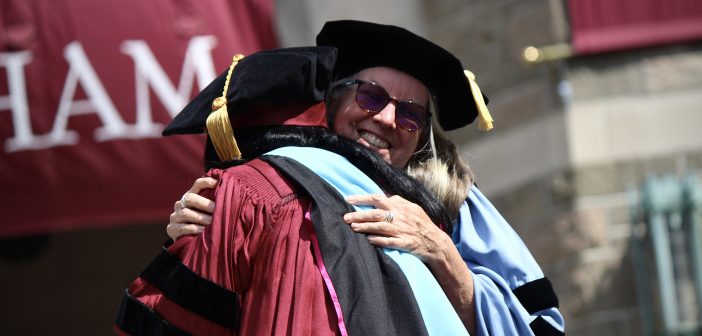 A graduate hugging former dean Virginia Roach.