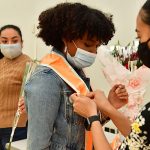 Graduate receiving orange stole at Latinx graduation