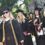 grads in sunglasses in line