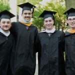 Men grads in caps and gowns--rugby players