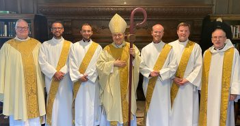 Father McShane, Joseph M. O’Keefe and Most Reverend James Massa stand with four newly ordained Jesuit priests
