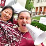 Move-in voluntters with megaphone and pom poms