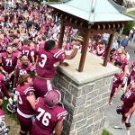Fordham football players ring the victory bell