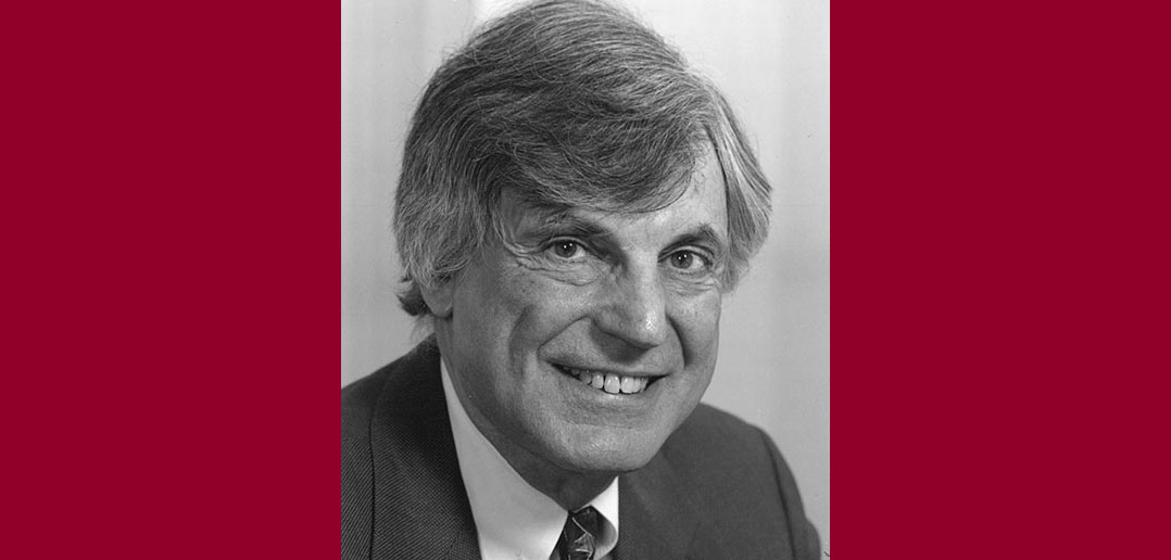 A black-and-white headshot of Edwin A. Cohen, a Fordham graduate and trustee fellow, against a maroon background