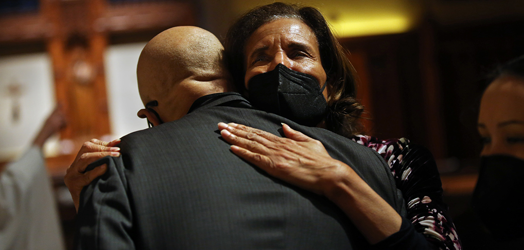 Dean Stovall's widow, Denise Herd, embraces his cousin Jack Smith at the memorial. 