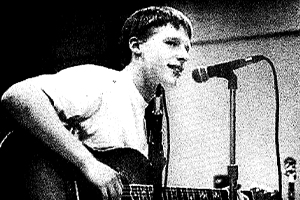 A photo of Kevin Devine playing guitar during his time as a Fordham student. From The Observer photo archives.