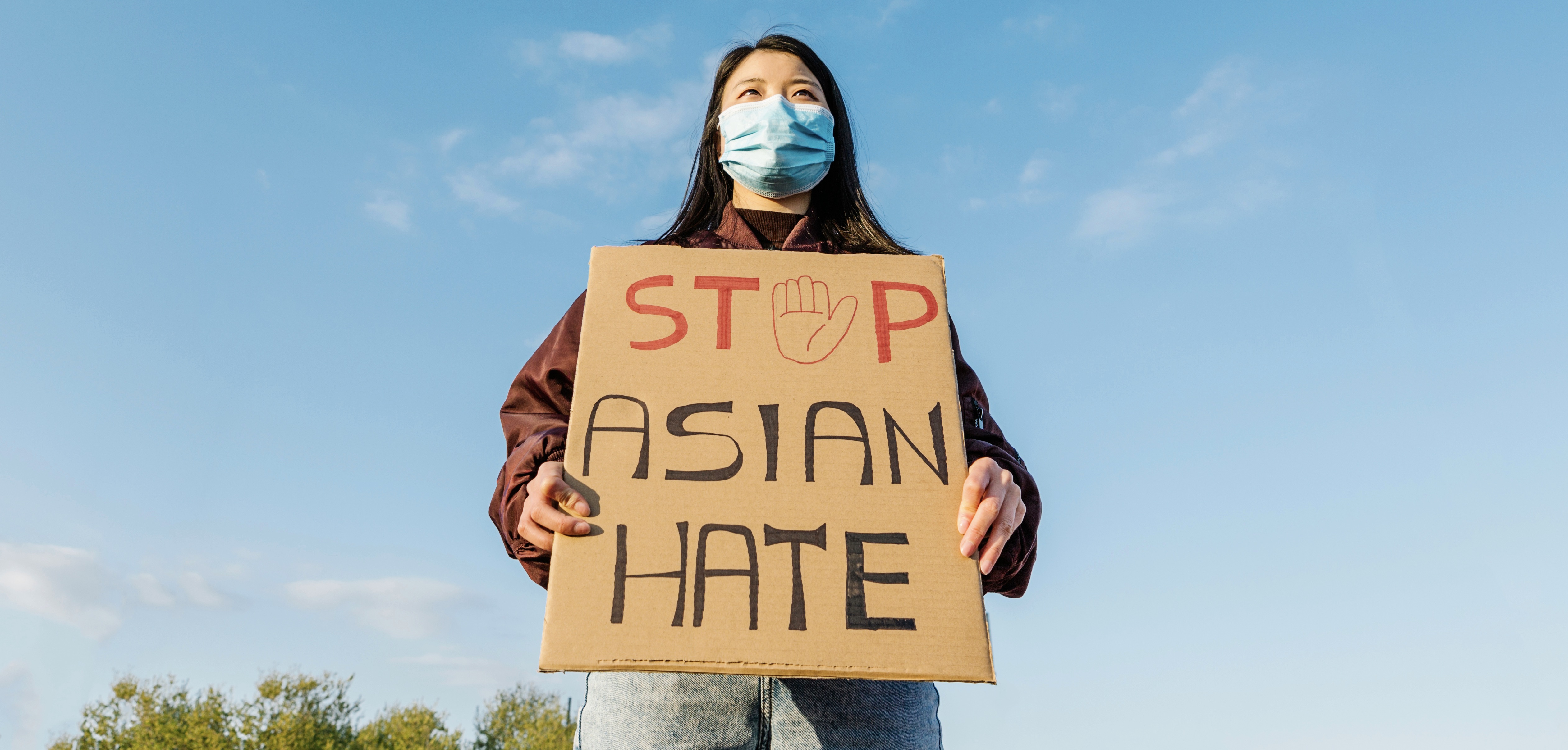 Young Chinese woman protesting against hate in the outbreak situation of coronavirus infection or Covid-19 - Stop asian hate fight campaign