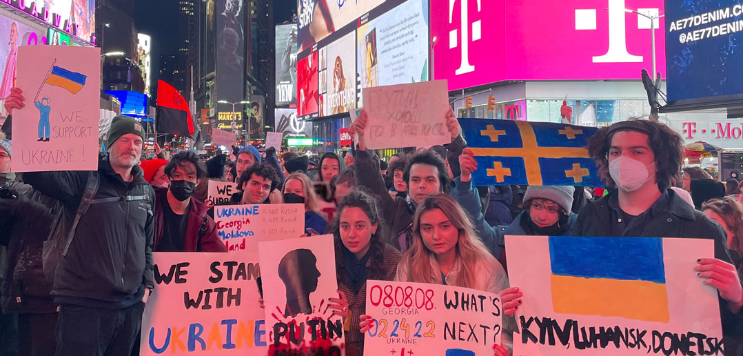 Students hold signs in Times Square