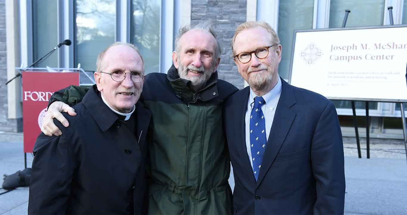 Father McShane standing next to his brothers Owen P. McShane, Jr., FCRH '67 and Thomas A. McShane, LAW '82