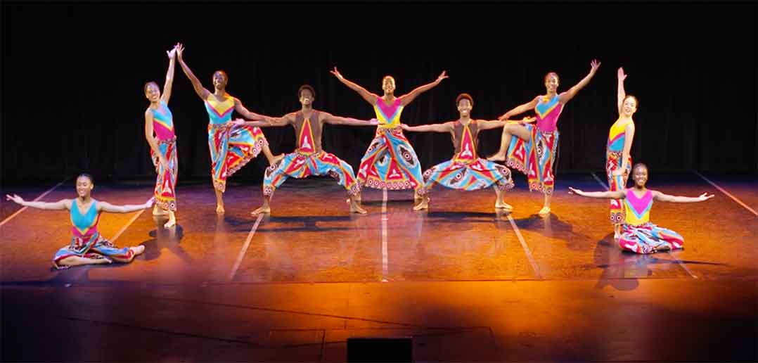 Dancers on stage in colorful outfits