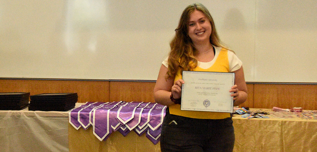 Young woman holding certificate and smiling