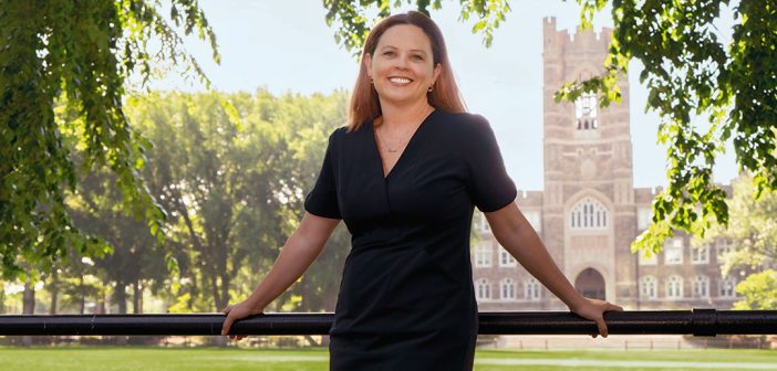 Fordham President Tania Tetlow poses in front of Edwards Parade with Keating Hall in the background