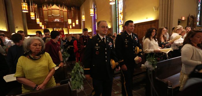 Two men in military uniforms process in University Church