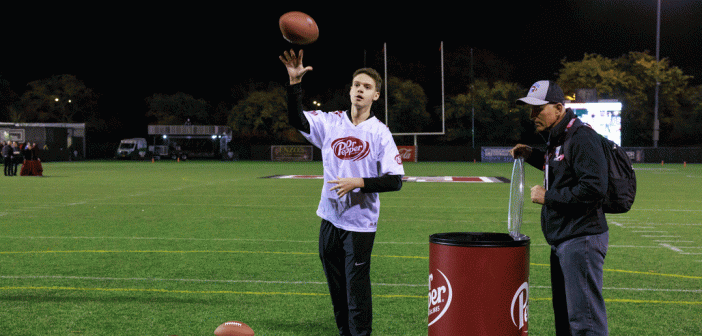 Young man tossing football