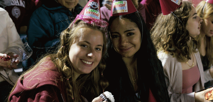 Students at Football game in birthday hats