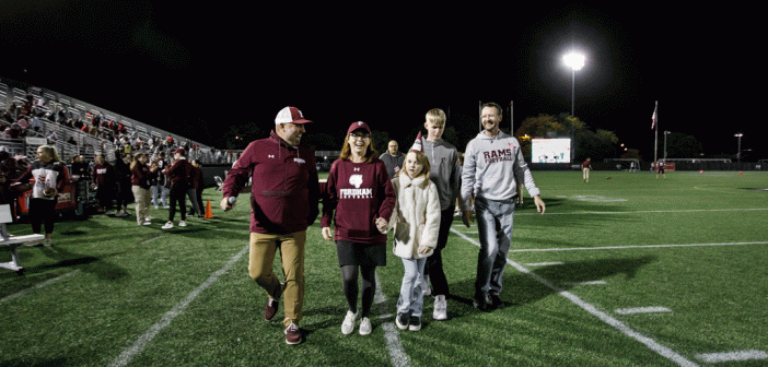 President Tetlow and Family walking on Football Field