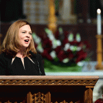 President Tetlow singing on altar