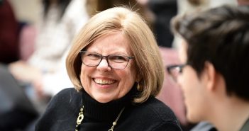 A smiling woman with glasses