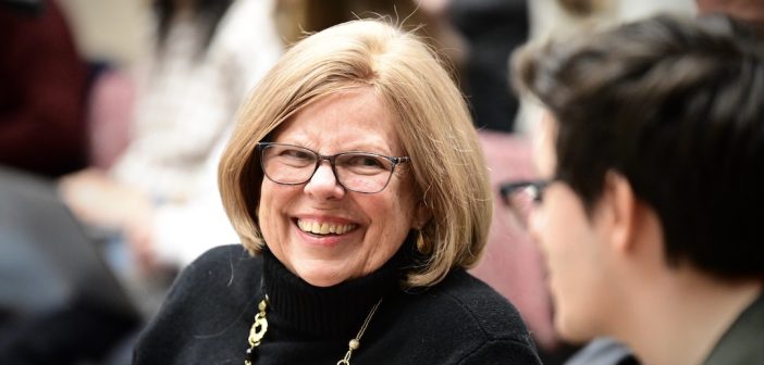 A smiling woman with glasses