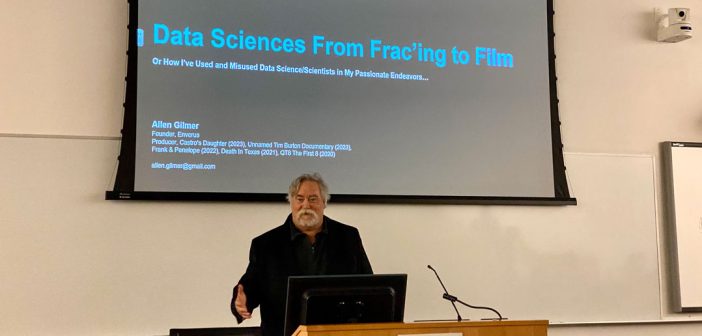 Man at a podium that says Data Sciences From Fracking to Film