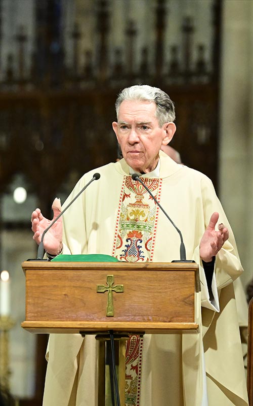 Joseph Parkes, S.J., at the altar at St. Patrick's Cathedral on March 22, 2023, during a Mass in memory of legendary sports broadcaster and Fordham graduate Vin Scully.