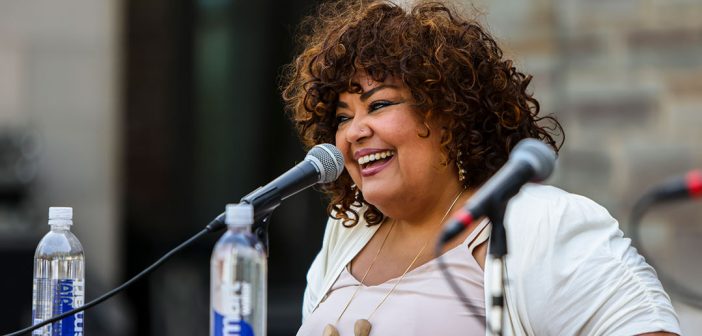 Elizabeth Yeampierre sitting in front of a microphone