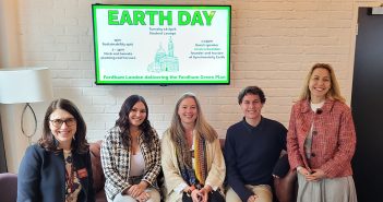 4 women and 1 man posing in front of Earth Day sign on TV
