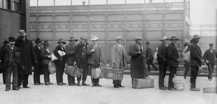 Italian men await admission processing at Ellis island, were among the 2,000 Italian immigrants the arrived on the Prinzess Irene which grounded on Fire Island sandbars. Ca. 1910.