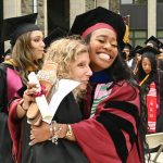 A GSE graduate hugging a professor