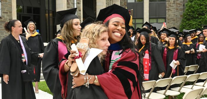 A GSE graduate hugging a professor