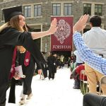 A GSE graduate giving a family member a high five