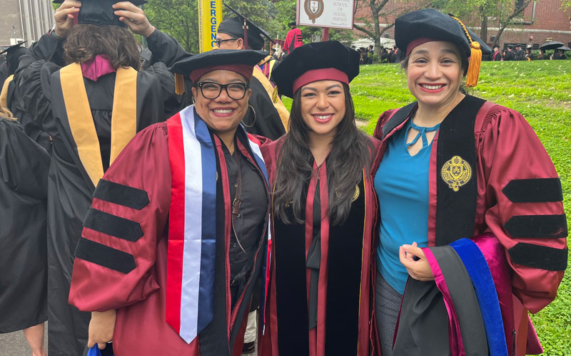 Three graduate students pose for a photo