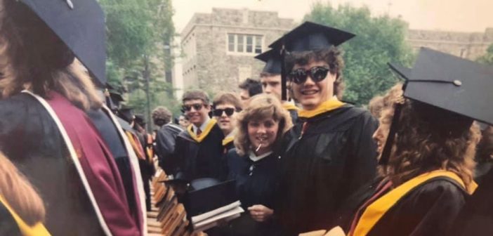 A group of Fordham grads in cap and gown at their 1988 graduation ceremony