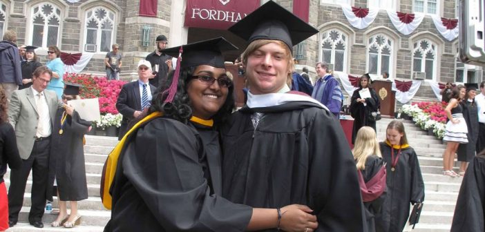 A pair of Fordham graduates hug after their graduation ceremony