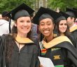 two Fordham graduates in cap and gown