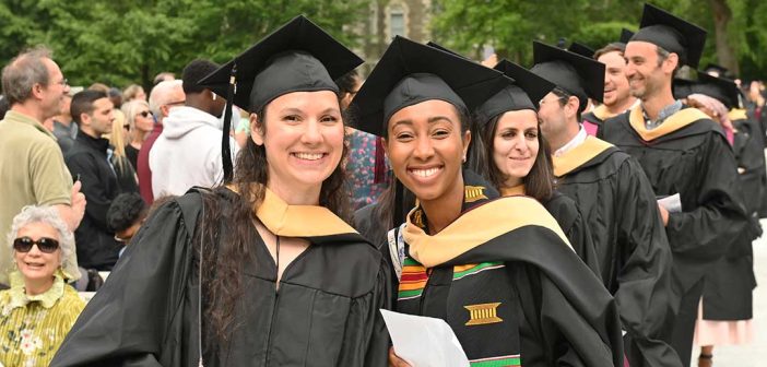 two Fordham graduates in cap and gown