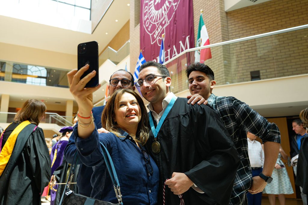 A male student and his family pose for a selfie