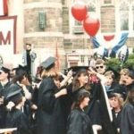A group of Fordham graduates in cap and gown at their graduation ceremony, circa mid-1980s