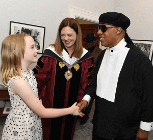 President Tetlow's daughter, Lucy, meets Stevie Wonder