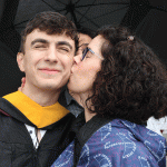 Mom kissing man graduate