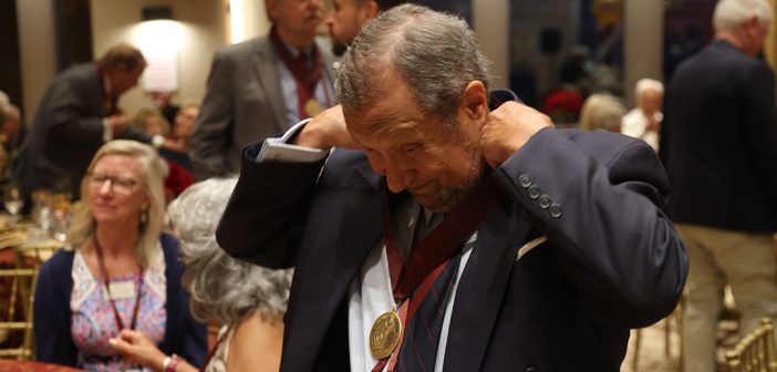 A man puts on his medal