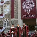 Tony Bennett standing on Keating Terrace with a Fordham banner behind him.