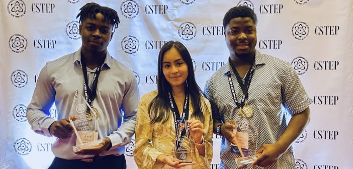 Latif Diaoune, Daphne Buitron, and Isaac Mullings stand and hold awards.