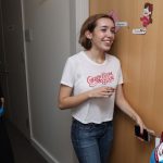 A student opens the door to her dorm.