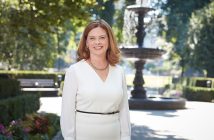 Fordham University President Tania Tetlow stands in front of Cunniffe Fountain on the Rose Hill campus