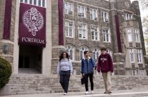 Three Fordham students walk in front of Keating Hall.