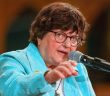 Sister Helen Prejean speaks at a microphone in front of the crowd at St. Paul the Apostle Church